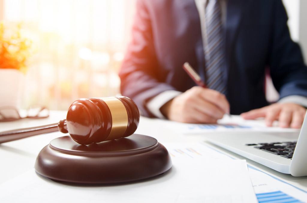 A consultation table where an accident attorney and a client review settlement options