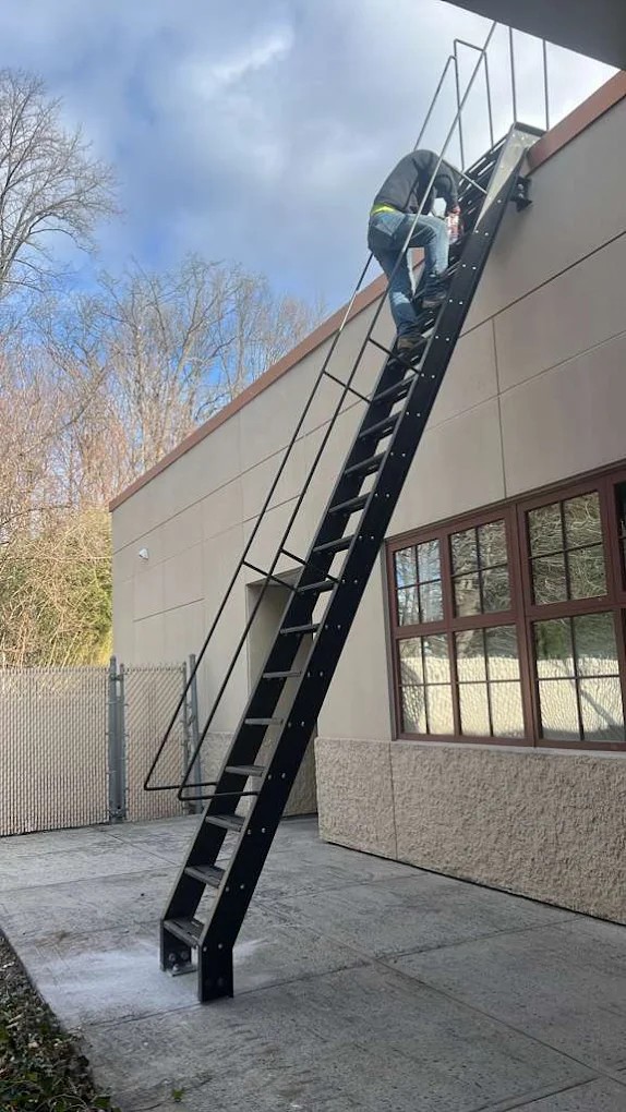 Roof railing installation on Brooklyn multi-family building — code-compliant steel guardrail system