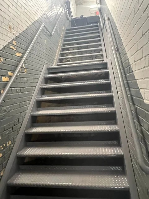 Steel Masters NYC team completing custom iron works installation on Brooklyn brownstone — resident-reviewed craftsmanship